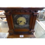 An early 20th Century mantel clock in architectural carved case.