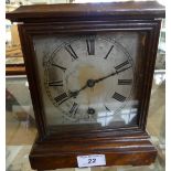 A Georgian style mahogany cased bracket clock with silvered dial, the movement marked W & H.