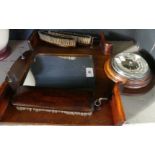 An early 20th Century oak wall mounted combination aneroid barometer mirror and brush stand