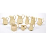 A collection of 19th century Ridgway and Staffordshire relief moulded jugs All of typical baluster