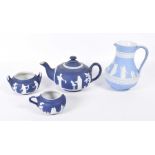 A collection of Jasperware To include a Wedgwood jug with relief moulded classical figures and an