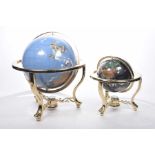 Two contemporary globes each mounted in gilt metal stands Each applied with semi precious stone