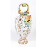 An Italian Majolica glazed water jug Of faceted ovoid form standing on a knopped pedestal stem,