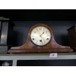An early 20th Century oak cased Napoleon hat mantel clock, the white dial and three train movement.