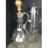 An early 20th Century white metal mounted claret jug of tapering form with etched fern decoration