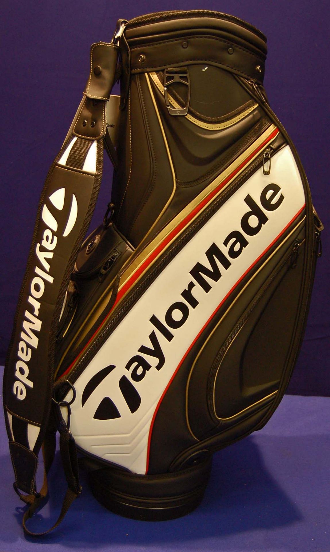 A TAYLORMADE TM16 Tour Cart Golf Bag in Black/White/Red/Gold featuring 6-Way Velour Top (8.5 inch