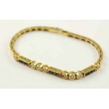 ARMBAND, 750/ooo Gelbgold, besetzt mit 8 Brillanten von zusammen ca. 0,4ct. und 9 Safircarees, L