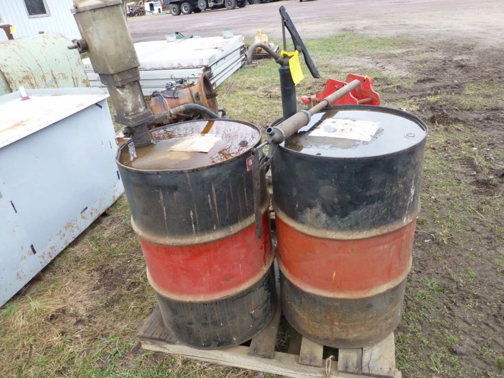 2 fuel barrels- w/ pump, hose, and reel