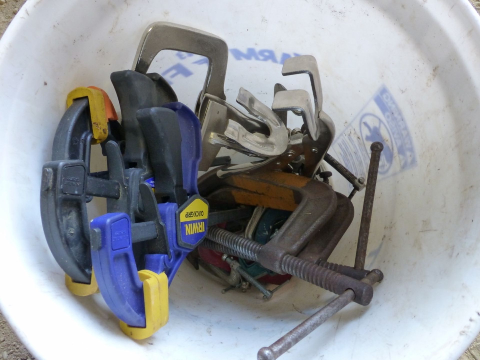 Bucket with several clamps, quikgrips, and c-clamps