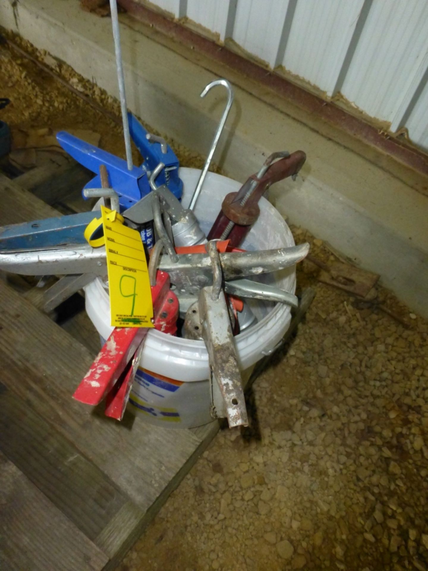 Pail with several caulk guns