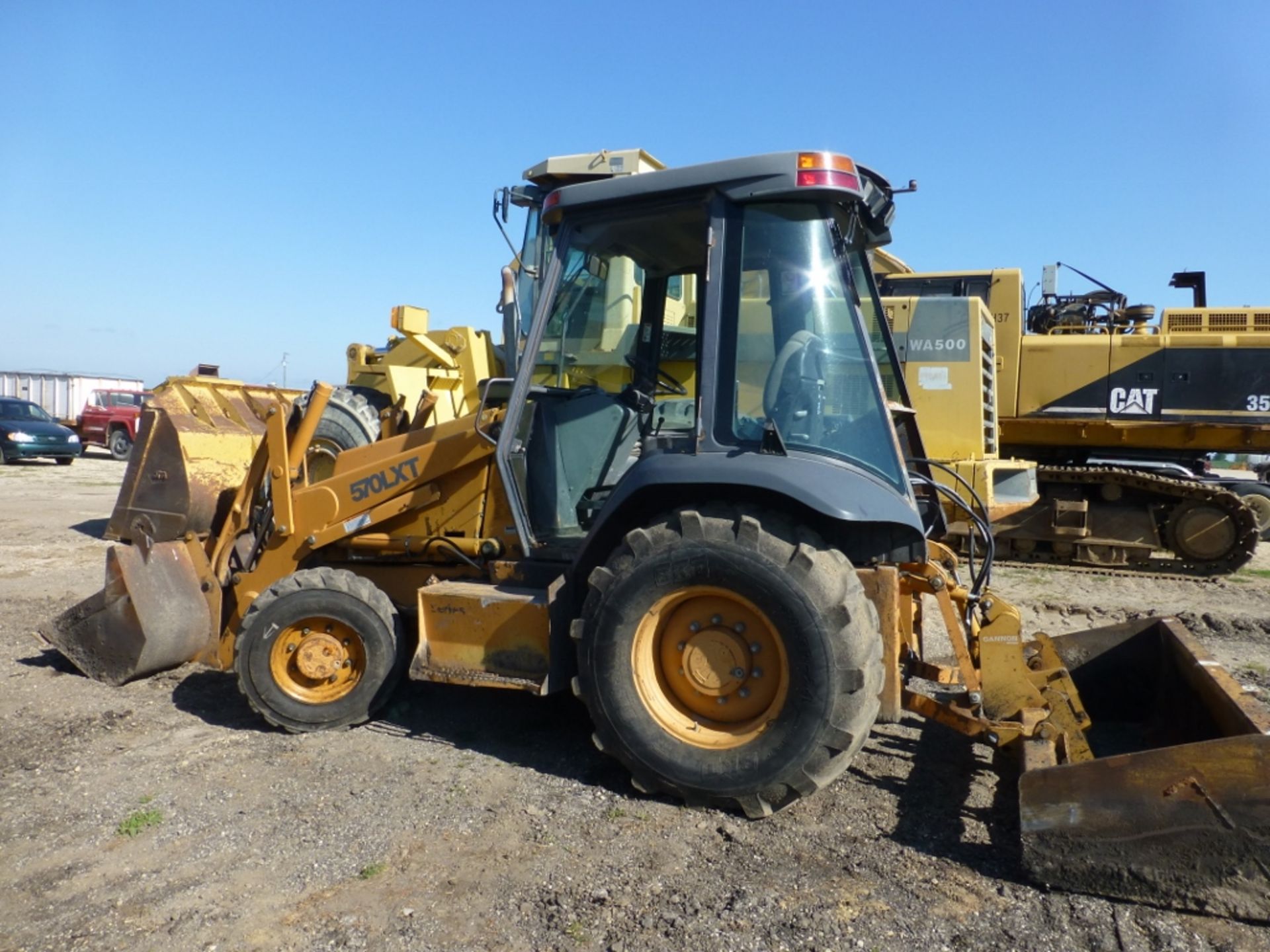 Case 570 LXT loader tractor with box scraper, missing left cab door, 8586 unverified hrs, front
