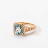 An 20 carat gold and aquamarine ring 21st century Centered by a square facetted aquamarine, to an