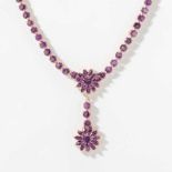 A gilt silver and amethyst necklace 21st century Centered by a flower motif with floral pendant,