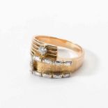 A 14 carat gold and diamond ring Circa 1980 Partly ribbed and brushed, set with one circular-cut