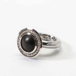 A metal, diamond and ebony ring, Puck Eigenmann, The Hague Circa 2000 Centered by an ebony circle,