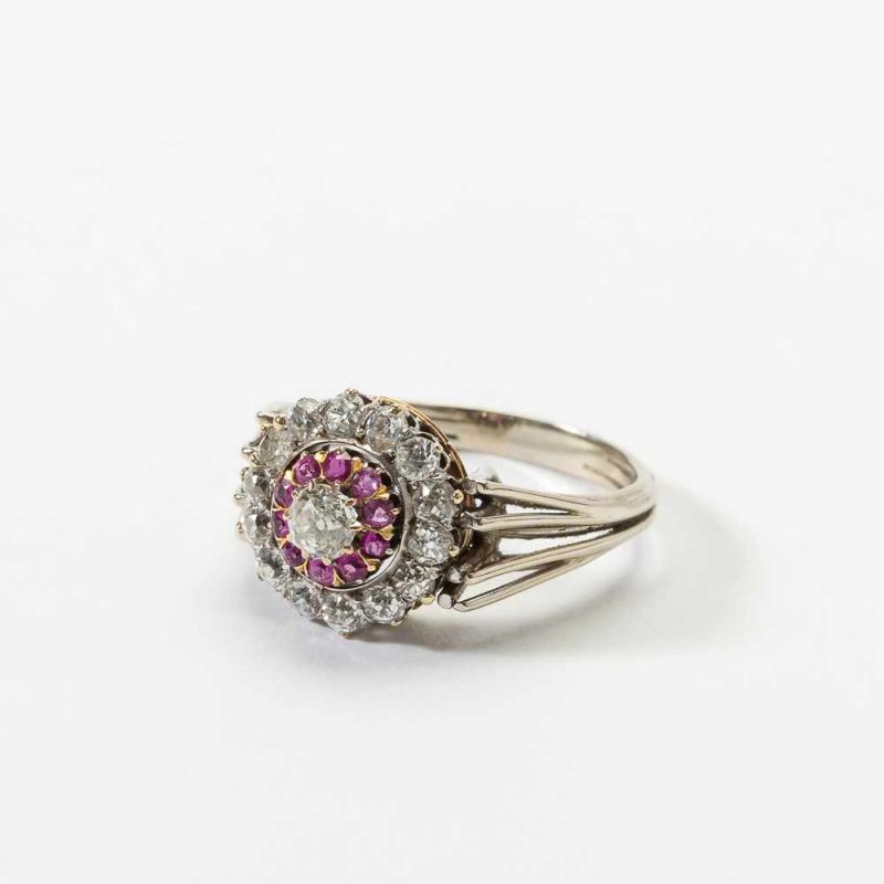 A 14 carat white gold, silver, diamond and ruby cluster ring 20th century Designed as a cluster of