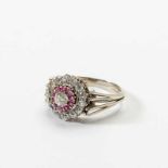 A 14 carat white gold, silver, diamond and ruby cluster ring 20th century Designed as a cluster of