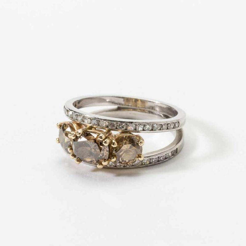 A platinum, 14 carat, brown diamond and diamond ring Late 20th century Centered by a cushion cut