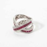 An 18 carat white gold, diamond and ruby bandring 21st century Designed as two crossed bands,