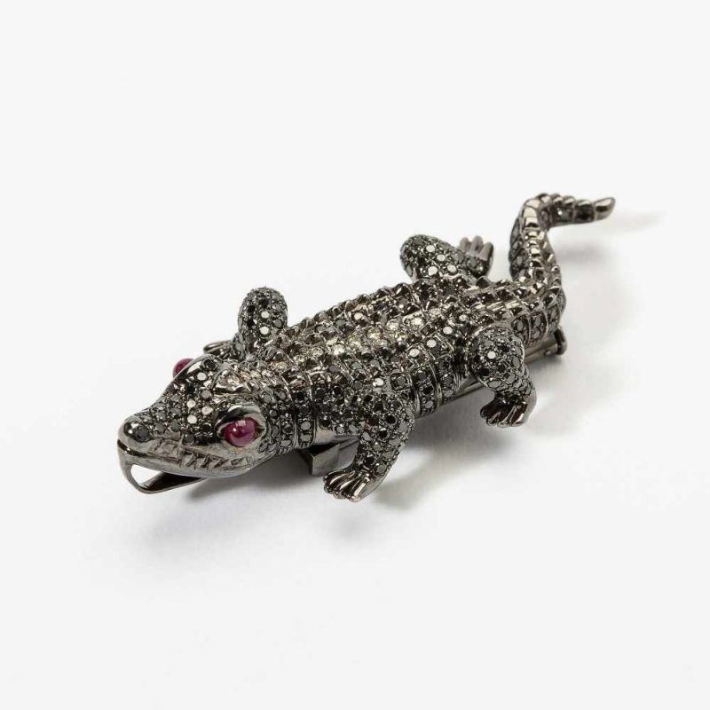 An 18 carat white gold, diamond and ruby crocodile pendant/brooch 21st century Set with black,