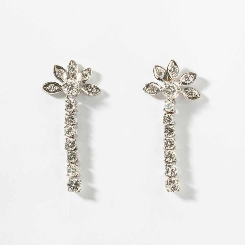 A pair of 14 carat white gold and diamond ear pendants Circa 1980 Designed as a flexible line of