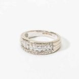 An 18 carat white gold and diamond bandring England, circa 1980 Centered by a line of marquize cut