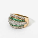An 18 carat gold, diamond and emerald bandring France, second part 20th century Centered by a