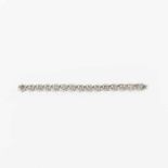 An 18 carat white gold and diamond bracelet Circa 1970 The horse-shoe designed links centered by a