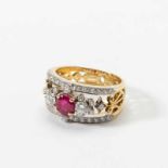 An 18 carat gold, diamond and ruby band ring Circa 1990 Centered by a facetted ruby, flanked by