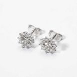 A pair of 18 carat white gold and diamond earstuds 21st century Each designed as a floral motif