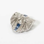 An Art Deco 18 carat white gold, diamond and sapphire clip Circa 1925 Old-cut diamond set, with