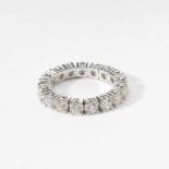 An 18 carat white gold and diamond eternity band21st centuryThe flexible ring set with seventeen