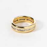 An 18 carat gold and diamond eternity band ring21st centuryCentered by a line of princess-cut