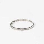 An 18 carat white gold and diamond bangle21st centuryCentered by a line of circular-cut diamonds, to