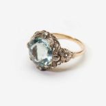 An 18 carat gold, silver, aquamarine and diamond ring20th centuryCentered by a facetted