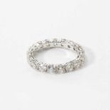 An 18 carat white gold and diamond eternity band ring21st centurySet with eighteen circular-cut