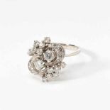 A 14 carat white gold and diamond ringCirca 1970Centered by two larger circular-cut diamonds and