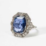 A platinum, diamond and blue sapphire cluster ring20th centuryThe ring centered by a cushion-cut