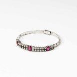 An 18 carat white gold, ruby and diamond braceletCirca 1970Designed as a double line of circular-cut