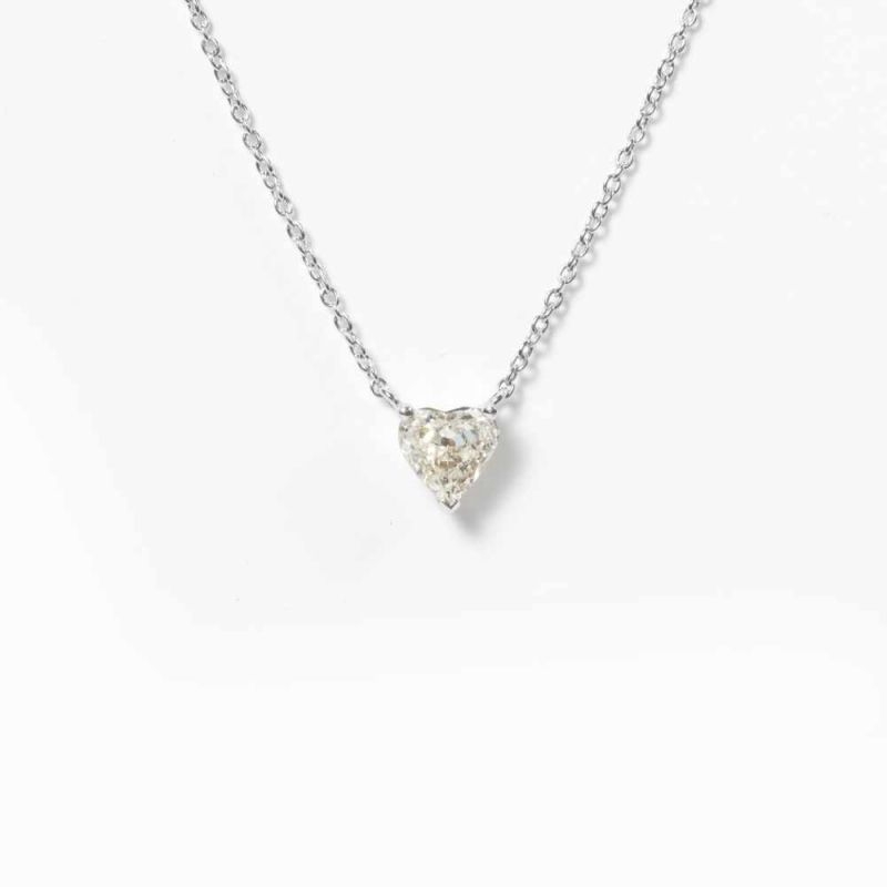 An 18 carat white gold necklet with diamond pendant21st centuryThe necklet suspending a heart-shaped