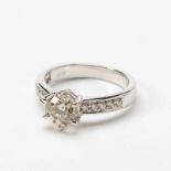 An 18 carat white gold and diamond single stone ring21st centuryThe band partly set with circular-