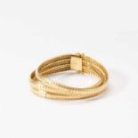 An 18 carat gold braceletCirca 1970Designed as three flexible satined bands to a gold clasp.Gross