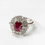 A 14 carat white gold, diamond and ruby cluster ringCirca 1970Centered by an oval-cut ruby (not