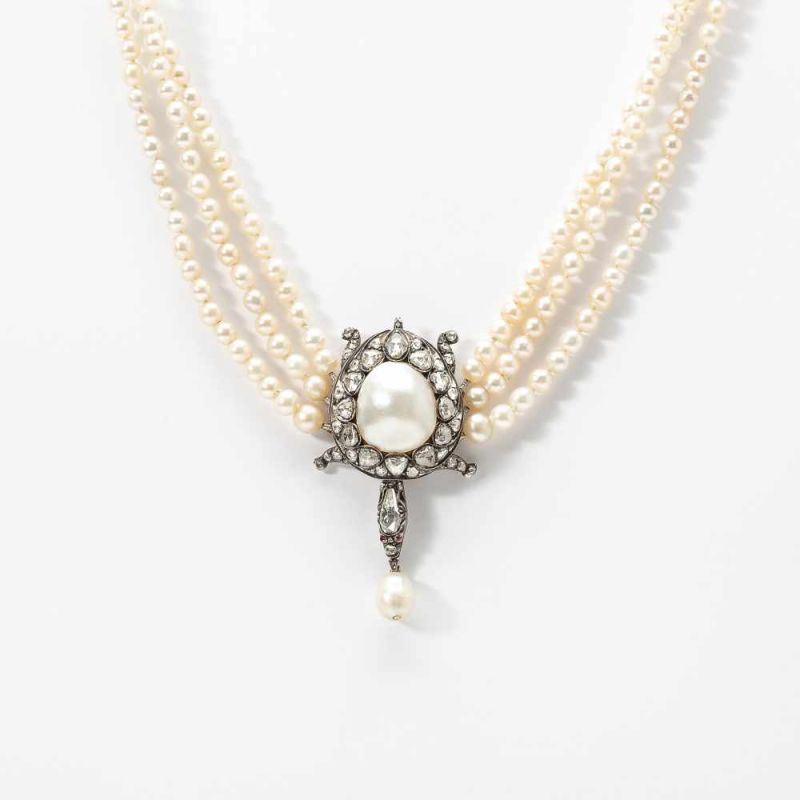 A three strand gold, silver, diamond and natural pearl necklace with an exceptionally large
