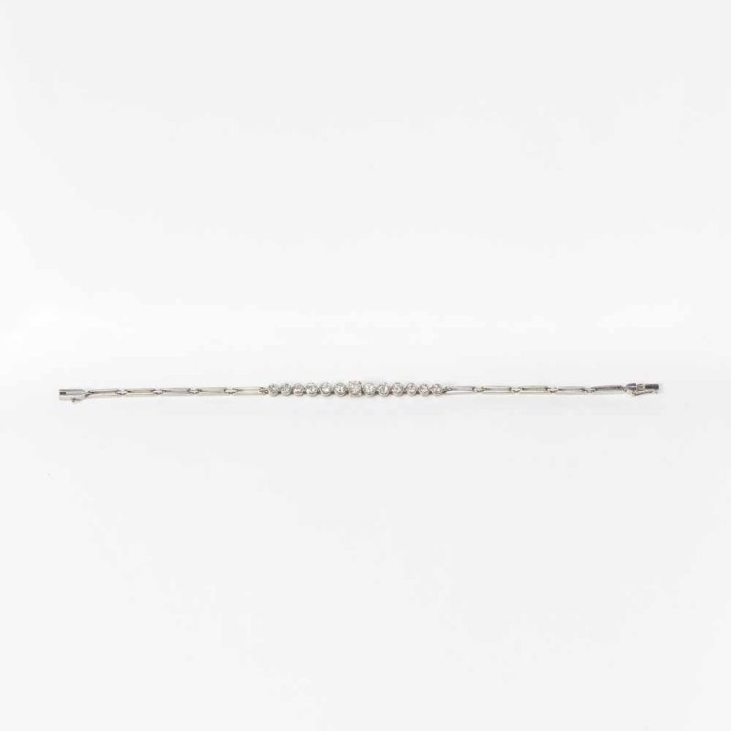 A 14 carat white gold and diamond line bracelet20th centuryDesigned as a graduating line of collet