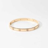 An 18 carat rose gold and diamond Cartier-style bangle21st centuryThe bracelet at intervals set with