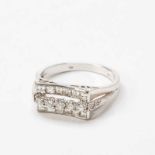 A 14 carat white gold and diamond ringCirca 1960Centered by a line of circular-cut diamonds, flanked