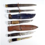 Two small Bowie knives, one with hawk pommel and stag grip, in associated leather scabbard,