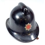 A mid-20th century Hampshire Fire Service fireman's helmet with stamp to underside 'NPV' and