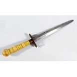 A 19th century dagger with turned bone handle, pierced eagle crossguard and tapering blade,